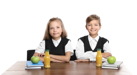 Happy children with healthy food for school lunch at desk on white background