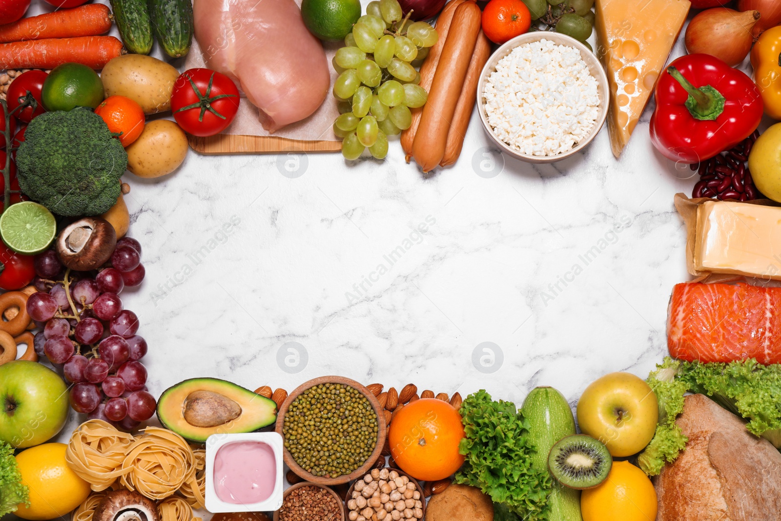 Photo of Frame of different products on white marble table, top view with space for text. Healthy food and balanced diet