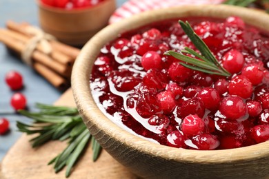 Fresh cranberry sauce with rosemary in bowl, closeup
