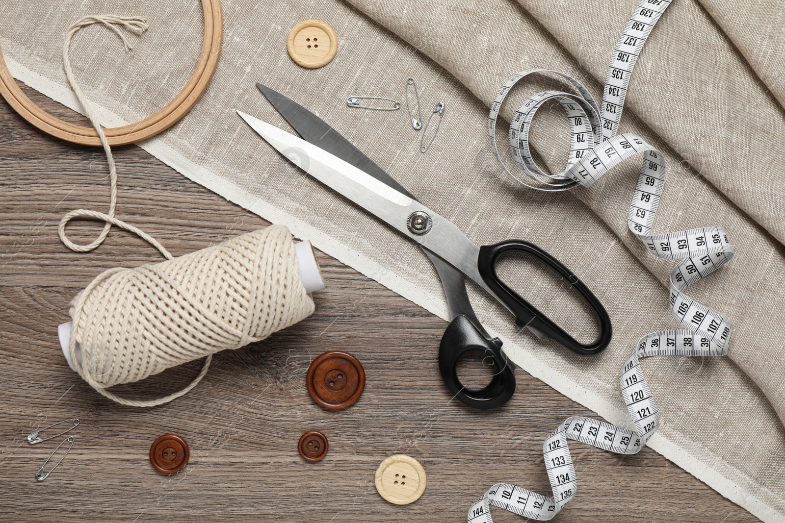 Photo of Flat lay composition with sewing accessories on wooden background
