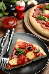 Slice of delicious pita pizza on table