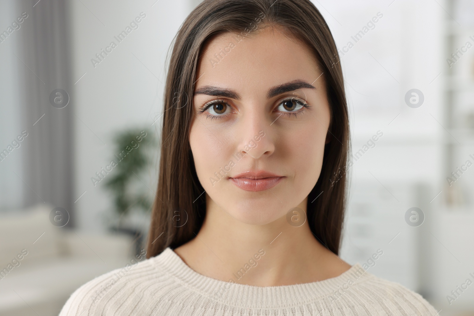 Photo of Portrait of beautiful young woman at home