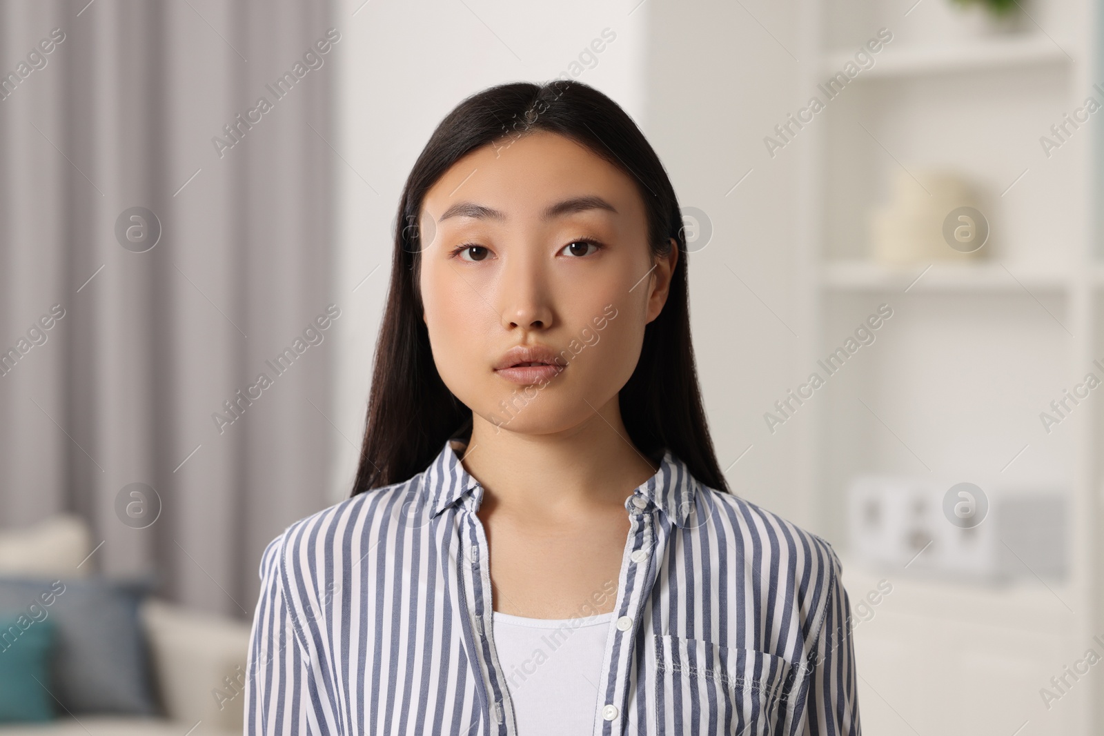 Photo of Portrait of beautiful young woman on blurred background