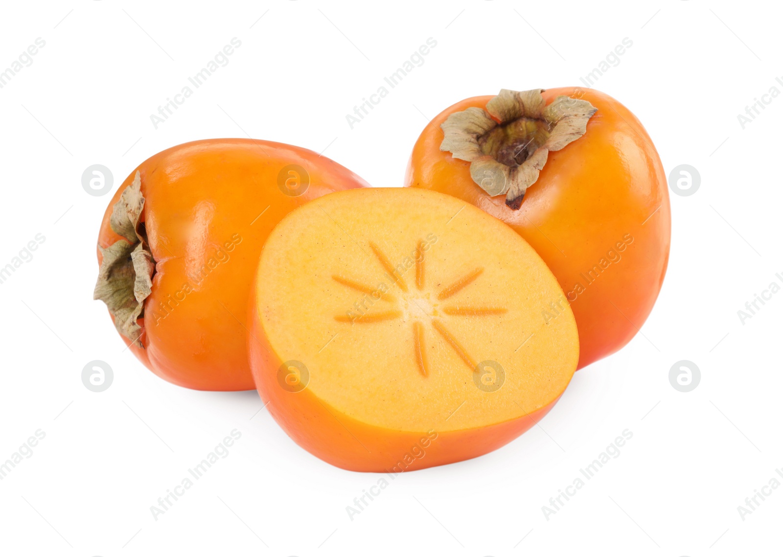 Photo of Whole and cut persimmon fruits isolated on white