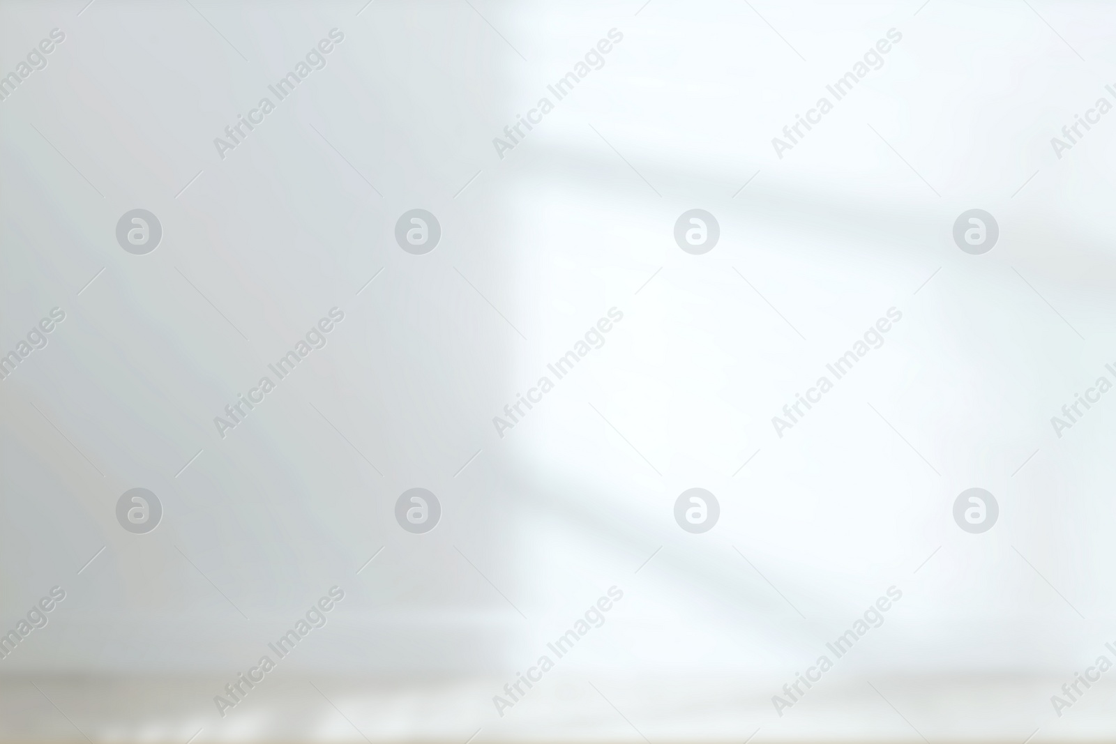 Image of Empty room with white wall and wooden floor, blurred view