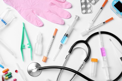 Flat lay composition with different medical objects on white background