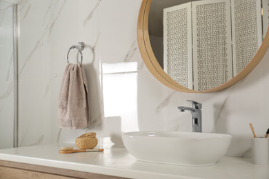 Bathroom interior with mirror, countertop and soft towel on wall