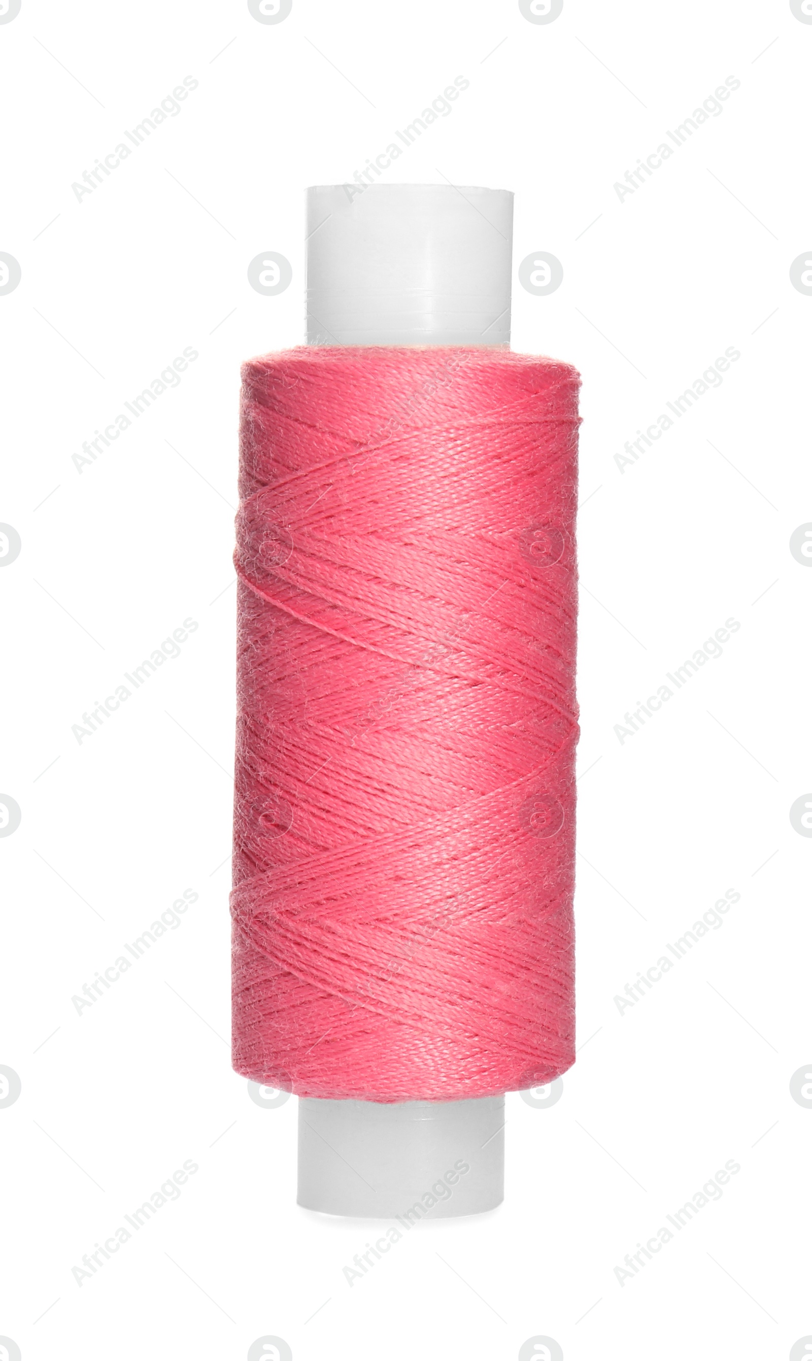 Photo of Spool of bright pink sewing thread isolated on white