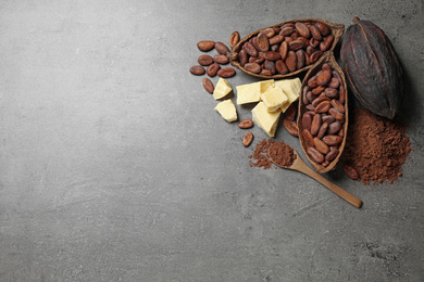 Flat lay composition with organic cocoa butter on grey table. Space for text