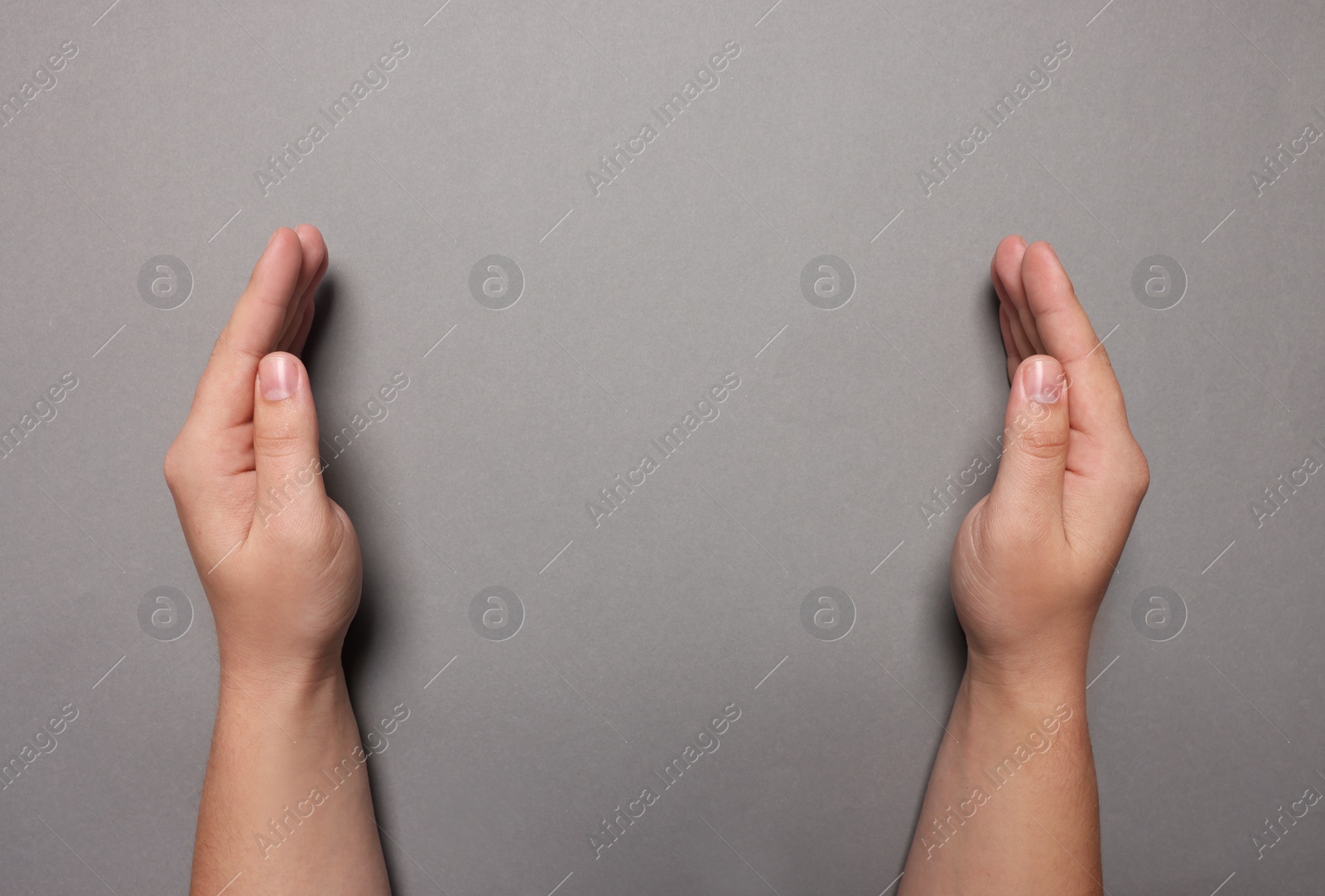 Photo of Woman holding on grey background, closeup of hands. Space for text