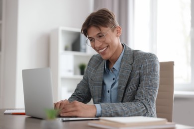 Photo of Man watching webinar at table in office