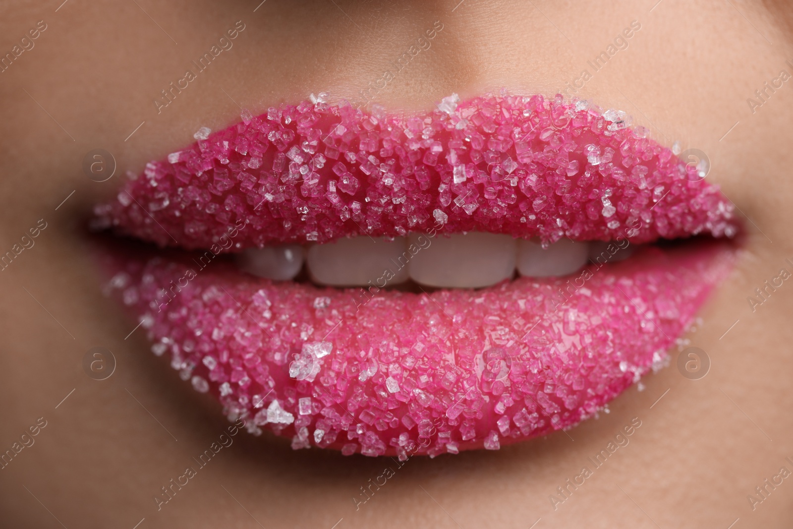 Photo of Young woman with beautiful lips covered in sugar, closeup