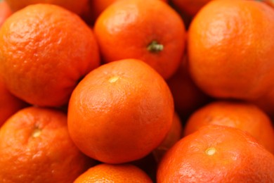 Many fresh ripe tangerines as background, closeup