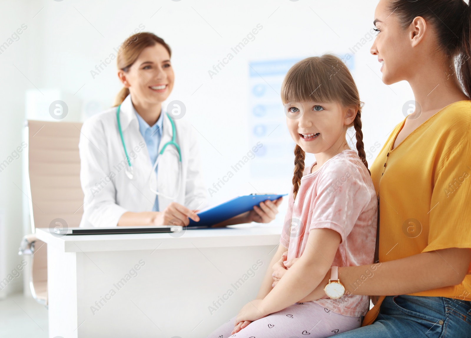 Photo of Little girl with parent visiting children's doctor in hospital