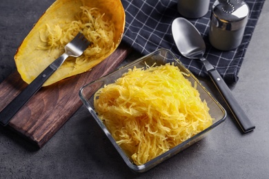 Photo of Bowl with cooked spaghetti squash on table