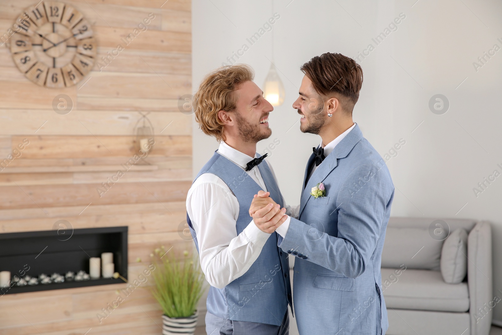 Photo of Happy newlywed gay couple dancing at home