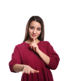 Photo of Woman showing HUSH gesture in sign language on white background