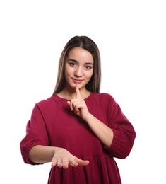 Woman showing HUSH gesture in sign language on white background