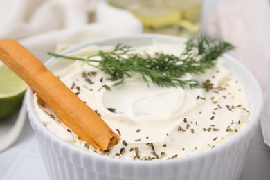 Delicious cream cheese with grissini stick and dill on white table, closeup