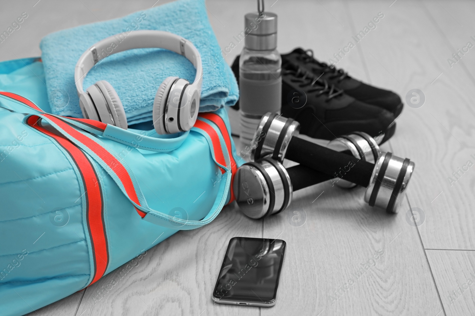 Photo of Sports bag and gym stuff on wooden floor