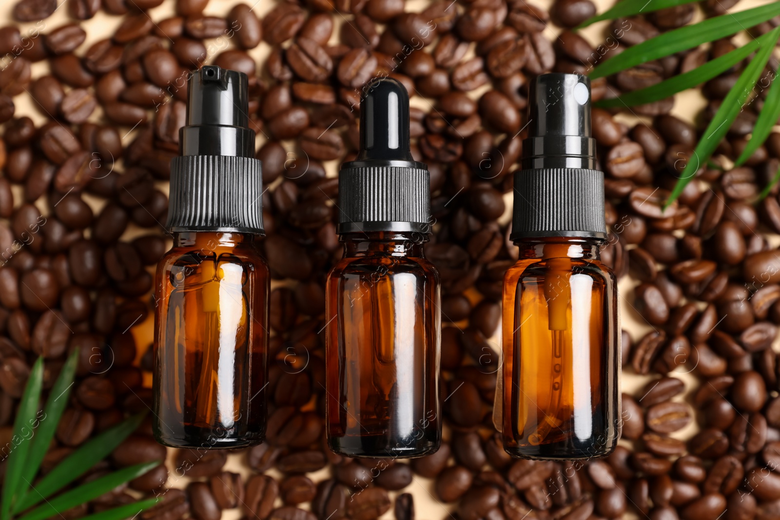 Photo of Flat lay composition with bottles of organic cosmetic products and coffee beans on beige background