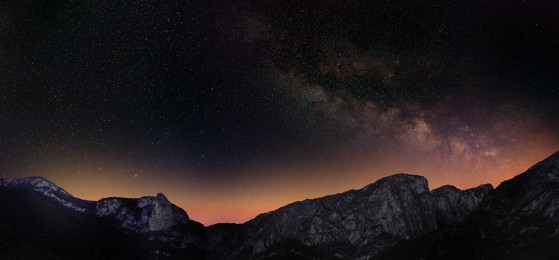 Picturesque view of starry night sky over mountains. Banner design