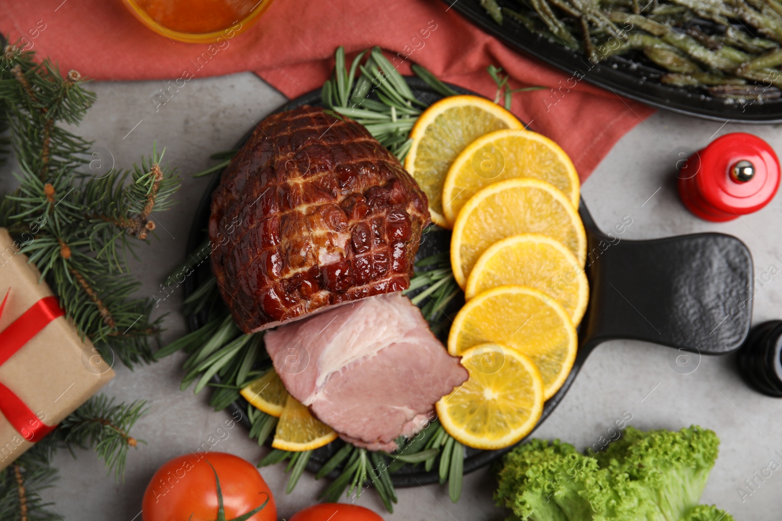 Photo of Festive flat lay composition with delicious ham on grey table. Christmas dinner