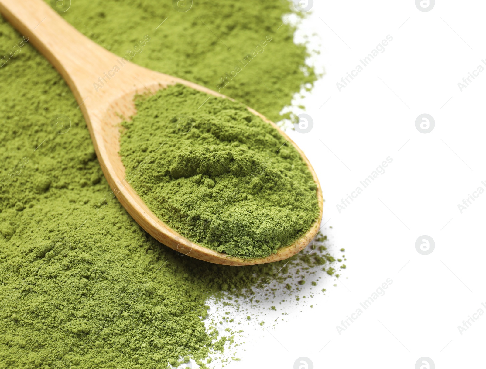 Photo of Green matcha powder and wooden spoon isolated on white