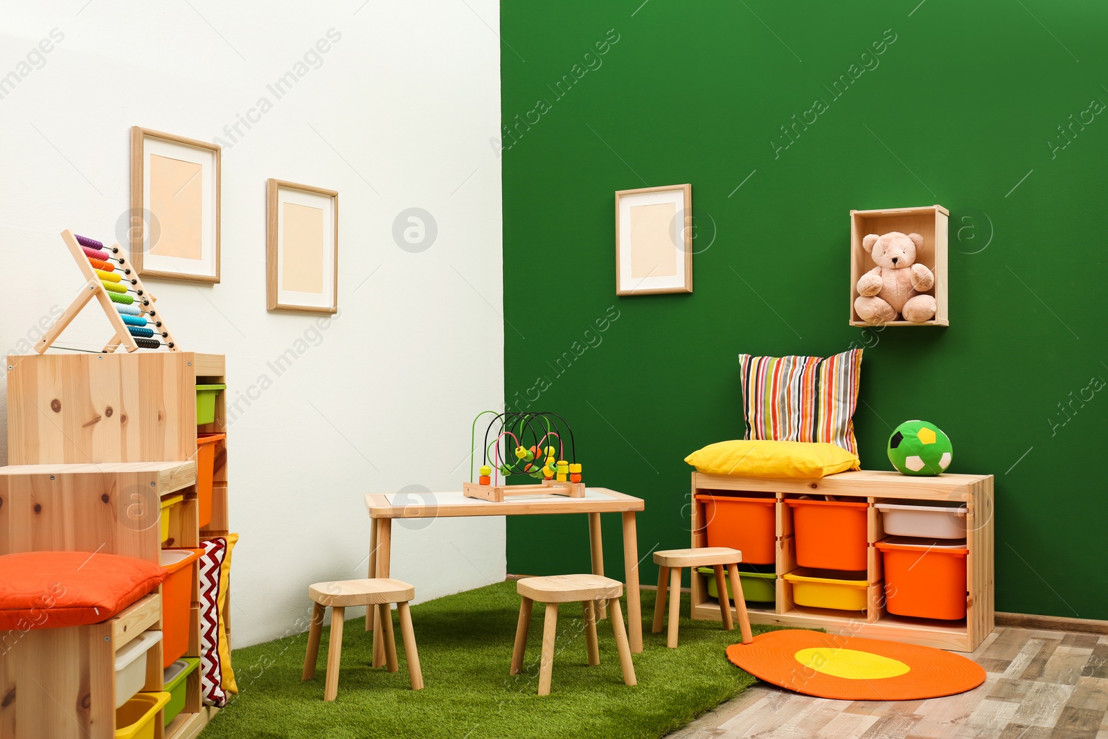 Photo of Stylish playroom interior with table and stools