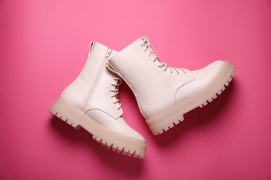 Photo of Pair of stylish leather shoes on pink background, flat lay