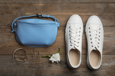 Stylish shoes, small woman's bag and accessories on wooden background, flat lay
