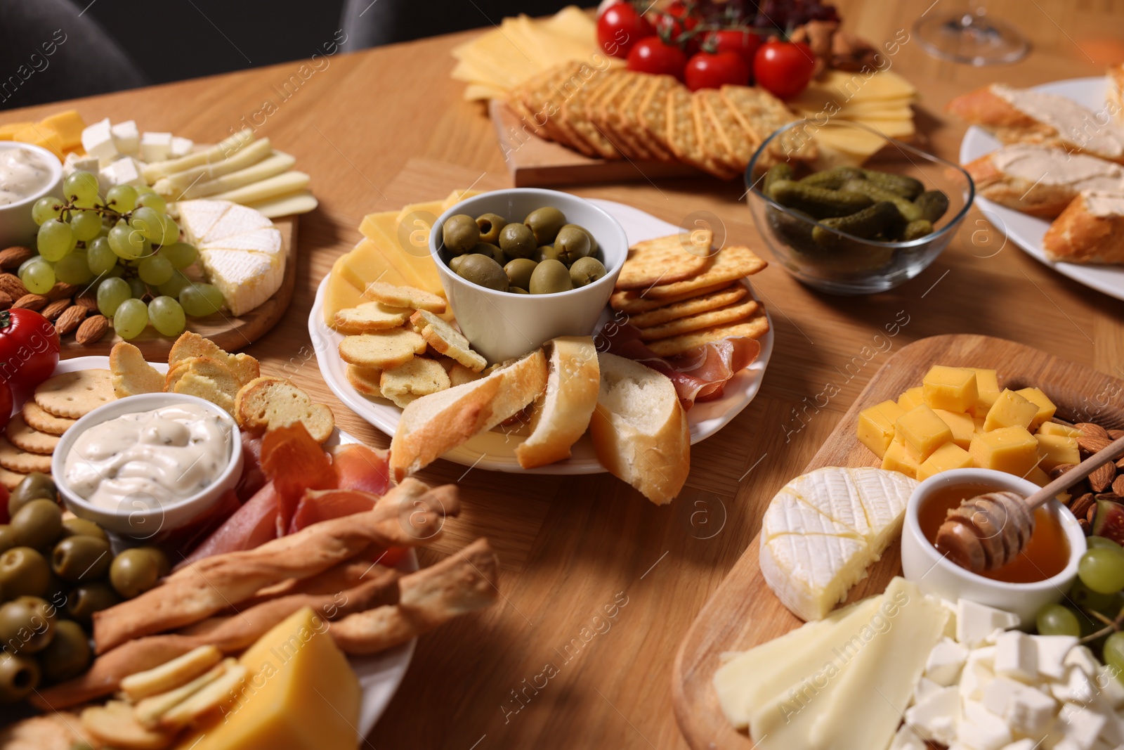 Photo of Assorted appetizers served on wooden table, closeup