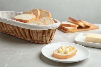 Slices of tasty fresh bread on light marble table