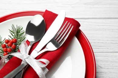 Photo of Christmas table setting on white wooden background, closeup