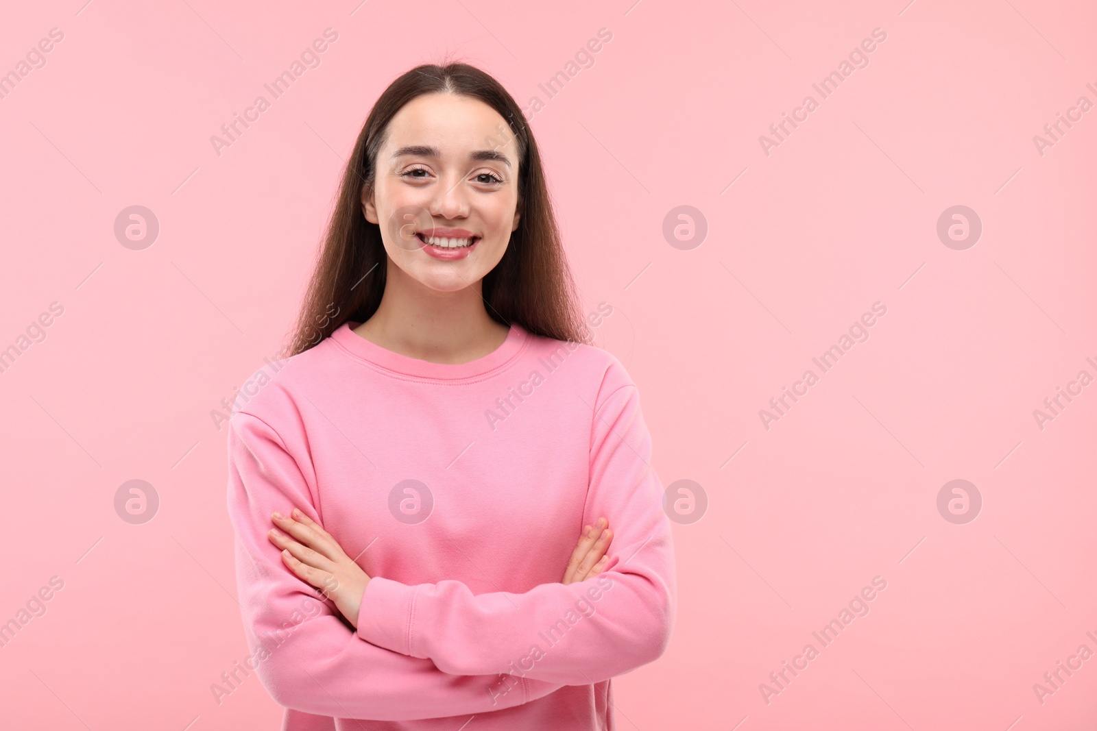 Photo of Beautiful woman with clean teeth smiling on pink background, space for text