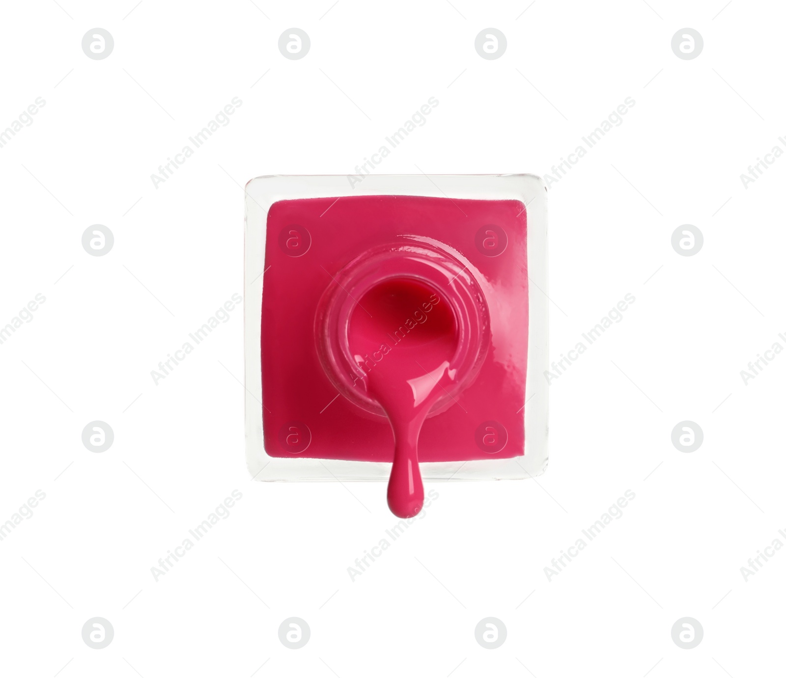 Photo of Pouring color nail polish from bottle on white background