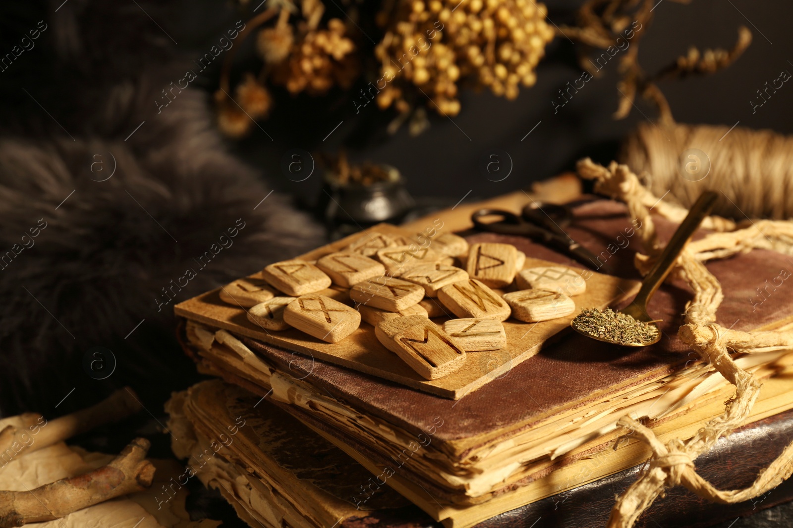 Photo of Many wooden runes and old books on altar