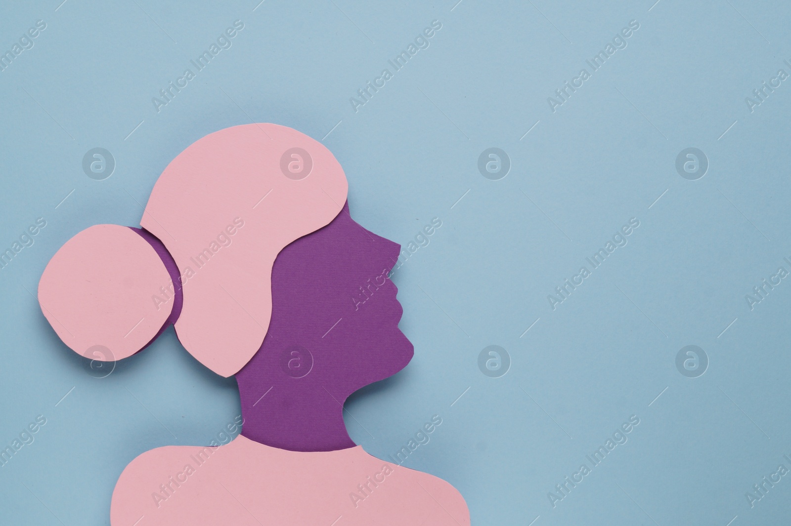 Photo of Woman's health. Female paper figure on light blue background, top view with space for text