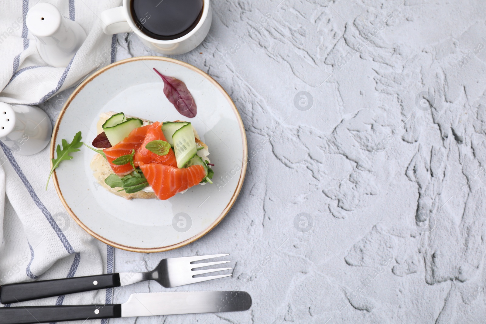 Photo of Flat lay composition of tasty bruschetta with salmon served on white textured table. Space for text