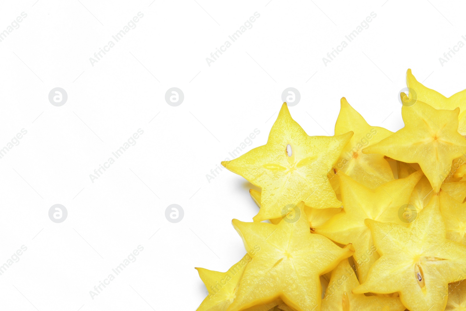 Photo of Pile of delicious carambola slices on white background, top view