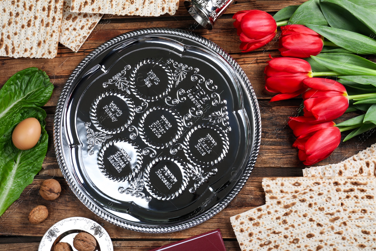 Photo of Flat lay composition with Passover Seder plate (keara) on wooden table. Pesah celebration