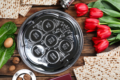 Photo of Flat lay composition with Passover Seder plate (keara) on wooden table. Pesah celebration