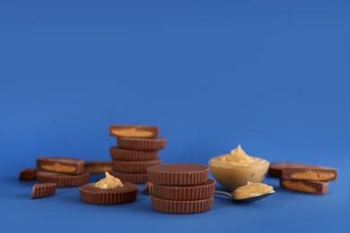 Photo of Sweet peanut butter cups on blue background