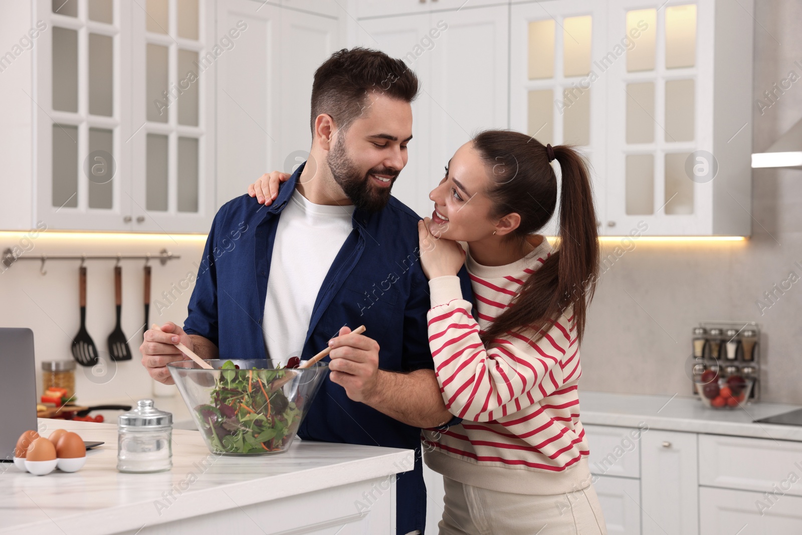 Photo of Happy lovely couple cooking together in kitchen