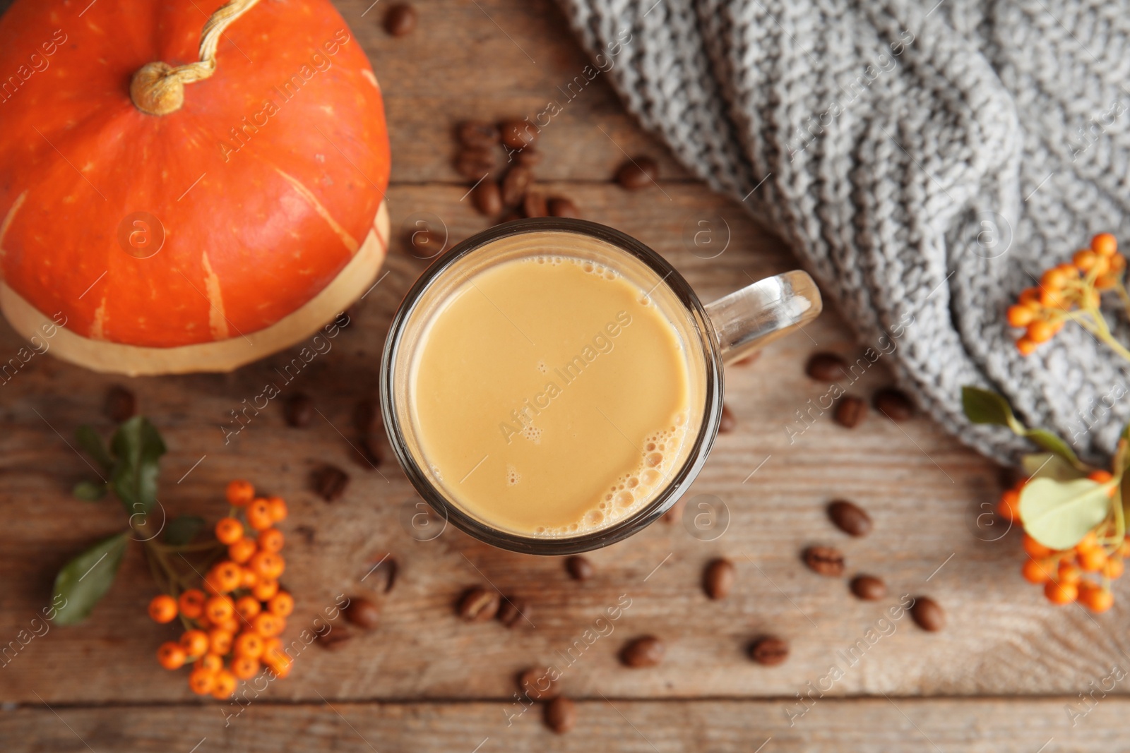 Photo of Flat lay composition with pumpkin spice latte on wooden background