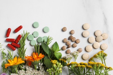 Photo of Different pills, herbs and flowers on white table, flat lay with space for text. Dietary supplements