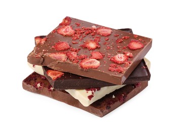 Photo of Chocolate bars with freeze dried strawberries on white background