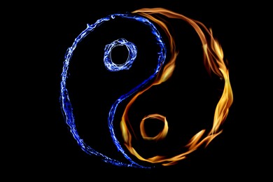 Fire flames and water splashes resembling Yin Yang symbol on black background. Feng Shui philosophy