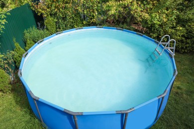 Photo of Above ground swimming pool on grass in backyard