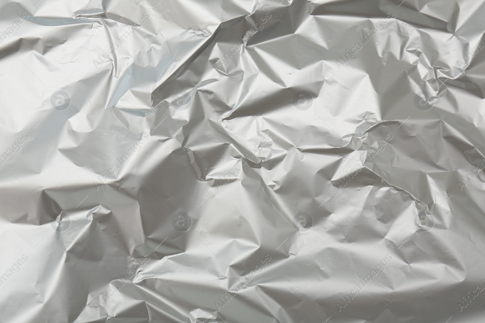 Photo of Crumpled silver foil as background, top view